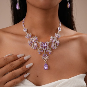 Detail of luxury purple crystal floral necklace and water drop earrings on model