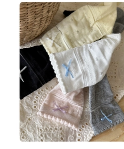 Close-up of kids mesh socks with bow details and scalloped cuffs in pastel colors