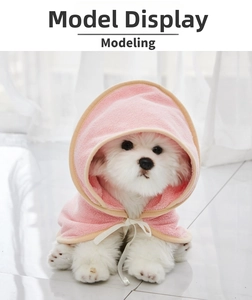Detail of pink microfiber hooded pet bathrobe with neck ties on a small dog