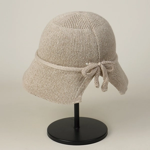 Detail of knitted bucket hat with a stylish bowknot on breathable mesh material