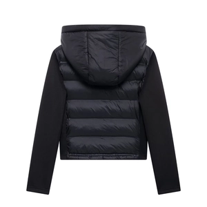 Detail of hybrid hooded jacket showing quilted torso and matte knit sleeve textures