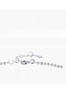 Detailed macro of S925 silver beaded bracelet with square Paraiba tourmaline and lobster clasp