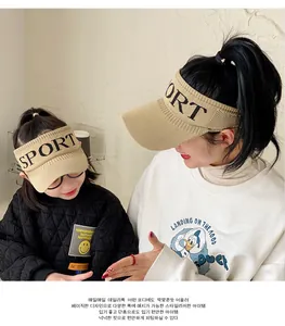 Detail of khaki knitted sun visor hat with sport embroidery for family matching