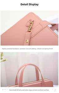 Detail of pink PU leather purse featuring dual gold zippers and textured litchi finish
