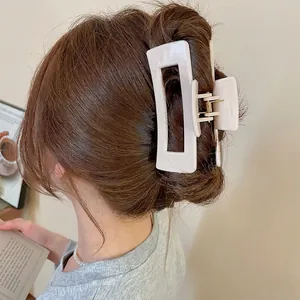 Creamy white square hollow hair claw clip shown on model for elegant hairstyle