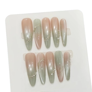 Handmade almond press-on nails with green and pink cat-eye gradient and pearl accents