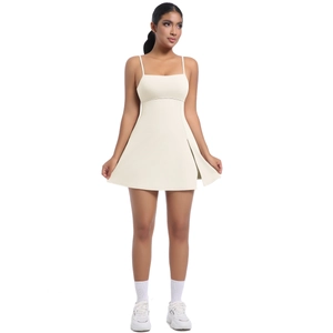 Detail view of the side slit and breathable fabric on a beige athletic tennis dress