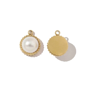 Detailed view of round gold pendant with white pearl inlay and textured metal reverse side