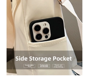 Detail view of the side storage pocket on an off-white canvas bag with a smartphone inside