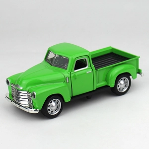 Close-up of green vintage alloy pickup truck model with silver metallic details