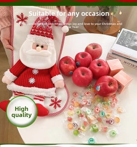 Detail of a plush Christmas stocking featuring a 3D Santa Claus and snowflake embroidery