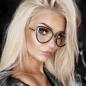 Close-up of stylish black cat-eye glasses with gold metal temples on a female model