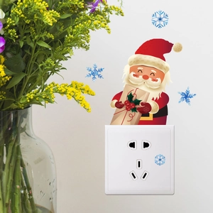 Glow-in-the-dark Santa Claus wall sticker with gift box above a power socket switch