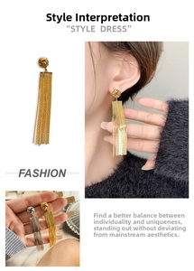Detail of long chain fringe earrings with woven metallic knot and 18K gold plated finish