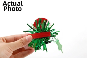 Detail of a Christmas duckbill hair clip with red velvet, green sequins and mesh tulle