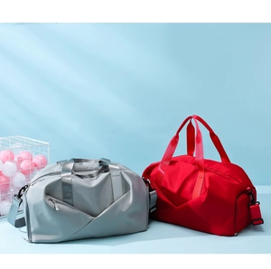 Waterproof travel bags in gray and red colors with wet-dry separation feature and shoulder strap