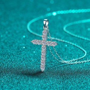 Elegant S925 sterling silver moissanite cross pendant necklace on a blue glitter background