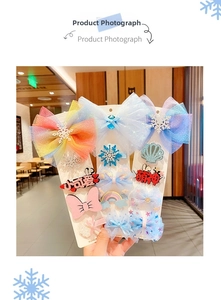 Close-up of glitter snowflakes and mesh bows on a 12-piece princess hair clip set