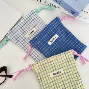 Three-piece checkered drawstring storage pouches in blue and yellow plaid patterns