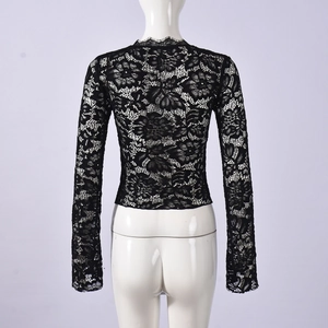Back view of a black lace long-sleeve crop top with intricate hollow-out texture patterns