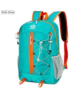 Detail of outdoor backpack featuring turquoise fabric and orange adjustable compression straps