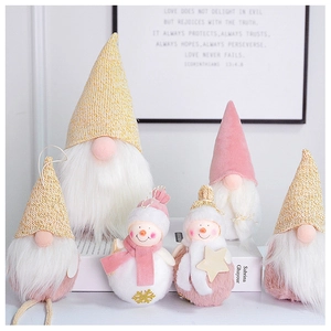 Pink and white plush Christmas gnomes and snowmen set displayed on decorative books