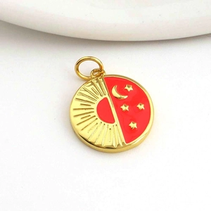 Macro shot of sun and moon star pendant with gold and red enamel finish details