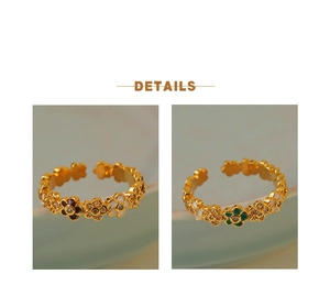 Close-up of gold flower rings with enamel petals and sparkling crystal centers