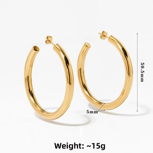 Detailed close-up of chunky C-shaped gold hoop earrings with 50.5mm outer diameter