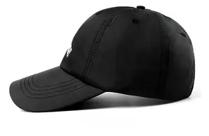 Detailed side view of black quick-dry baseball cap showing white embroidery and reinforced stitching