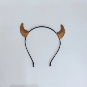 Detail view of gold sequin devil horns headband with a slim black plastic band