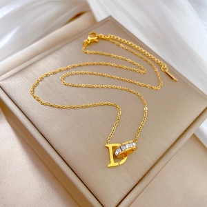 Minimalist gold titanium steel necklace with D-letter and crystal ring pendant on silk