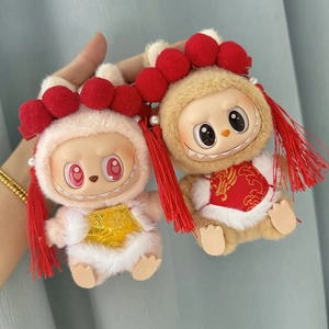 Detail of plush monster pendants wearing traditional Chinese red and gold festive outfits