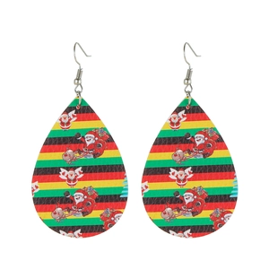 Close-up of teardrop faux leather earrings featuring festive Santa and reindeer patterns