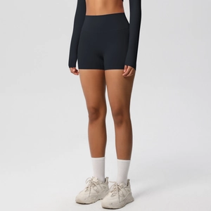 Detail of high-waisted black yoga shorts with wide waistband for tummy control