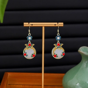 Detail of red bead and blue enamel plum blossom on Chinese style drop earrings