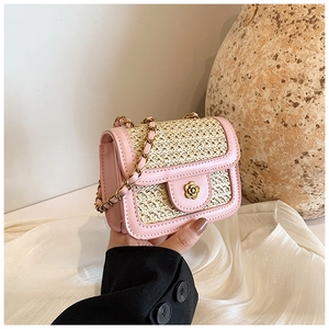 Detailed shot of pink leather and beige woven flap bag with floral gold clasp