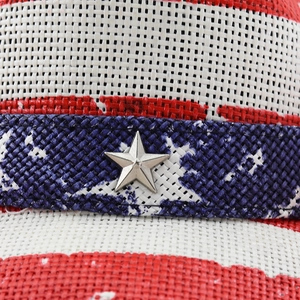 Macro shot of the woven flag hat texture with a decorative silver metal star on blue band