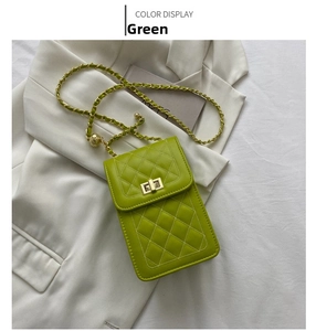 Detail of green quilted PU leather phone bag with gold twist lock and chain strap