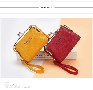 Detail of mini lychee leather coin purses with wristlet and metal kiss-lock closure
