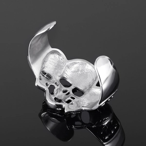 Macro shot of punk style stainless steel open cuff bracelet with skull hollow details