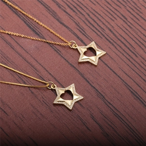 Minimalist gold star necklaces with zircon heart pendant on dark wood background