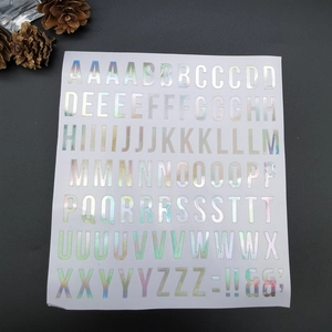 Holographic laser alphabet stickers with A-Z letters and symbols on a white sheet