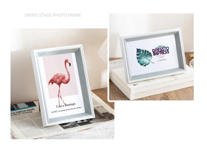 Detail of grey-blue wood grain photo frames with white matting and botanical prints