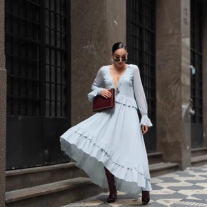 Light blue V-neck long sleeve tiered maxi dress with ruffles shown in outdoor setting