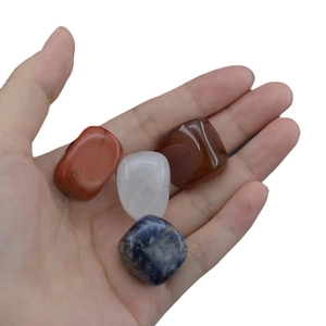 Polished natural chakra stones set including red, white, brown and blue healing crystals