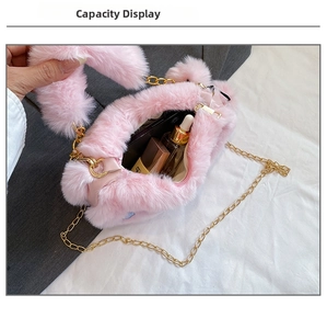 Internal view of pink plush heart bag showing capacity for cosmetics and gold chain