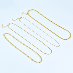 Set of four 18k gold plated titanium steel necklaces in Figaro and Cuban chain styles