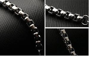 Macro shot of silver titanium steel box chain showing square links and polished texture