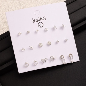 9-piece silver earring set with heart, star and pearl shapes on white display card